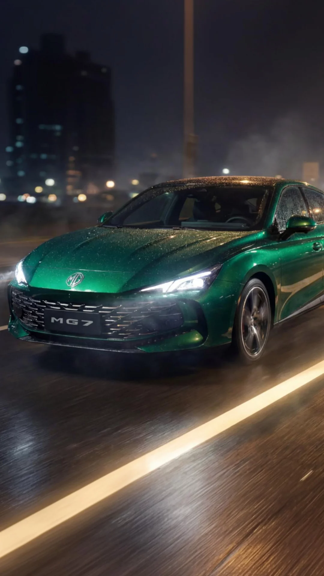 Green MG 7 driving on a wet road at night with active safety systems and illuminated headlights