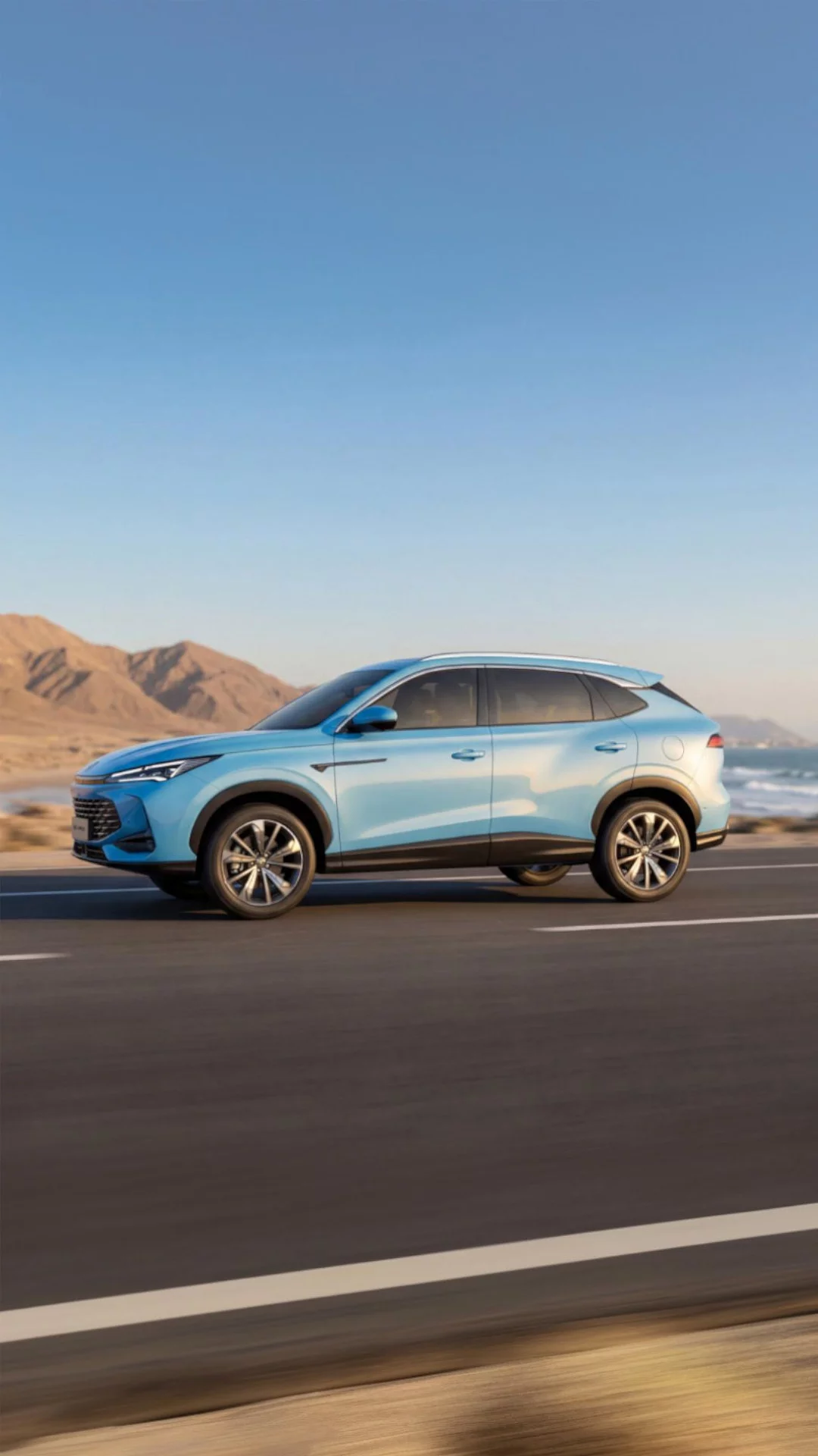 Light Blue MG HS Hybrid+ driving on a mountain road showing long-distance range capability