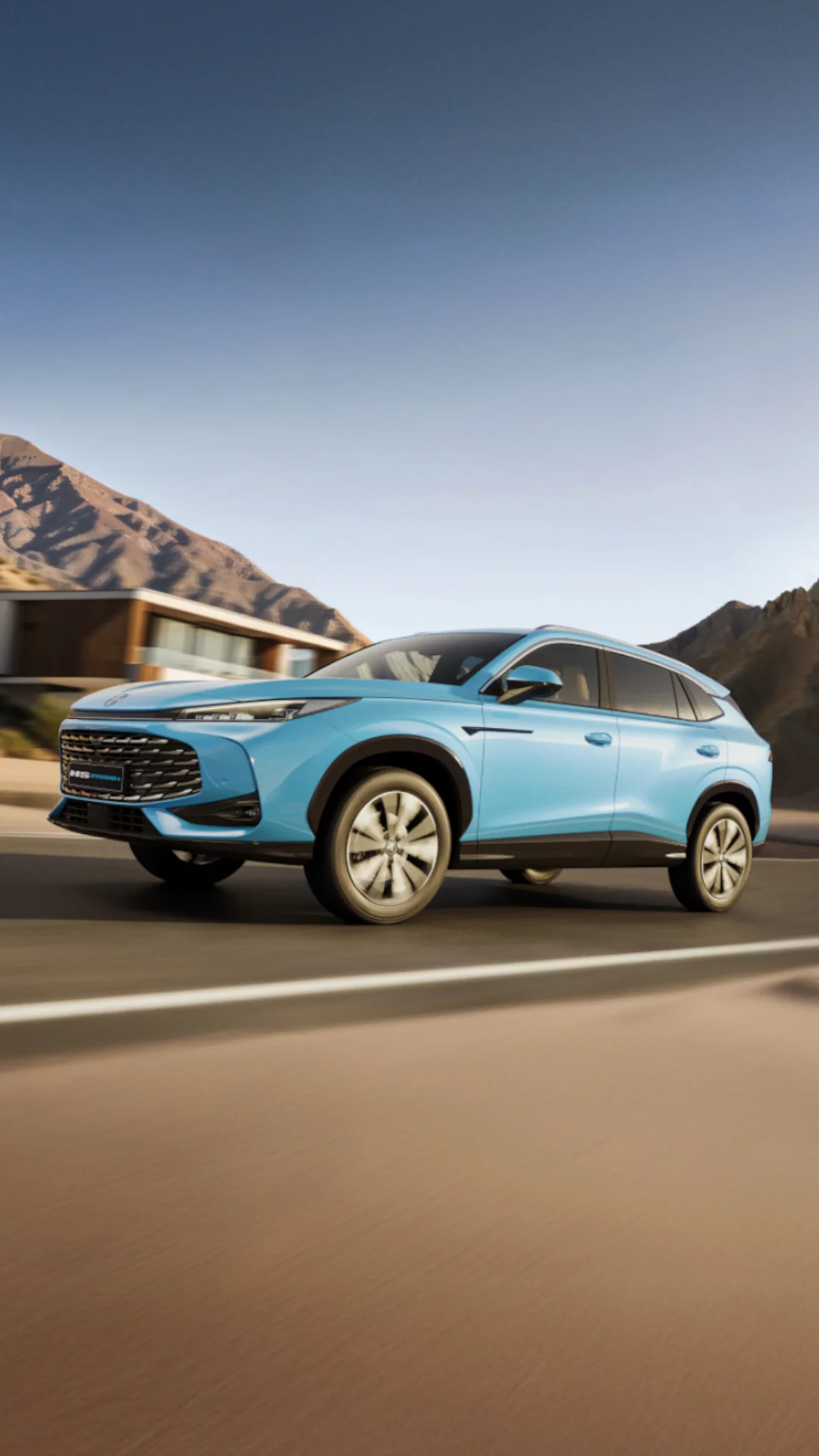 Light Blue MG HS Hybrid+ accelerating on a scenic coastal road at speed